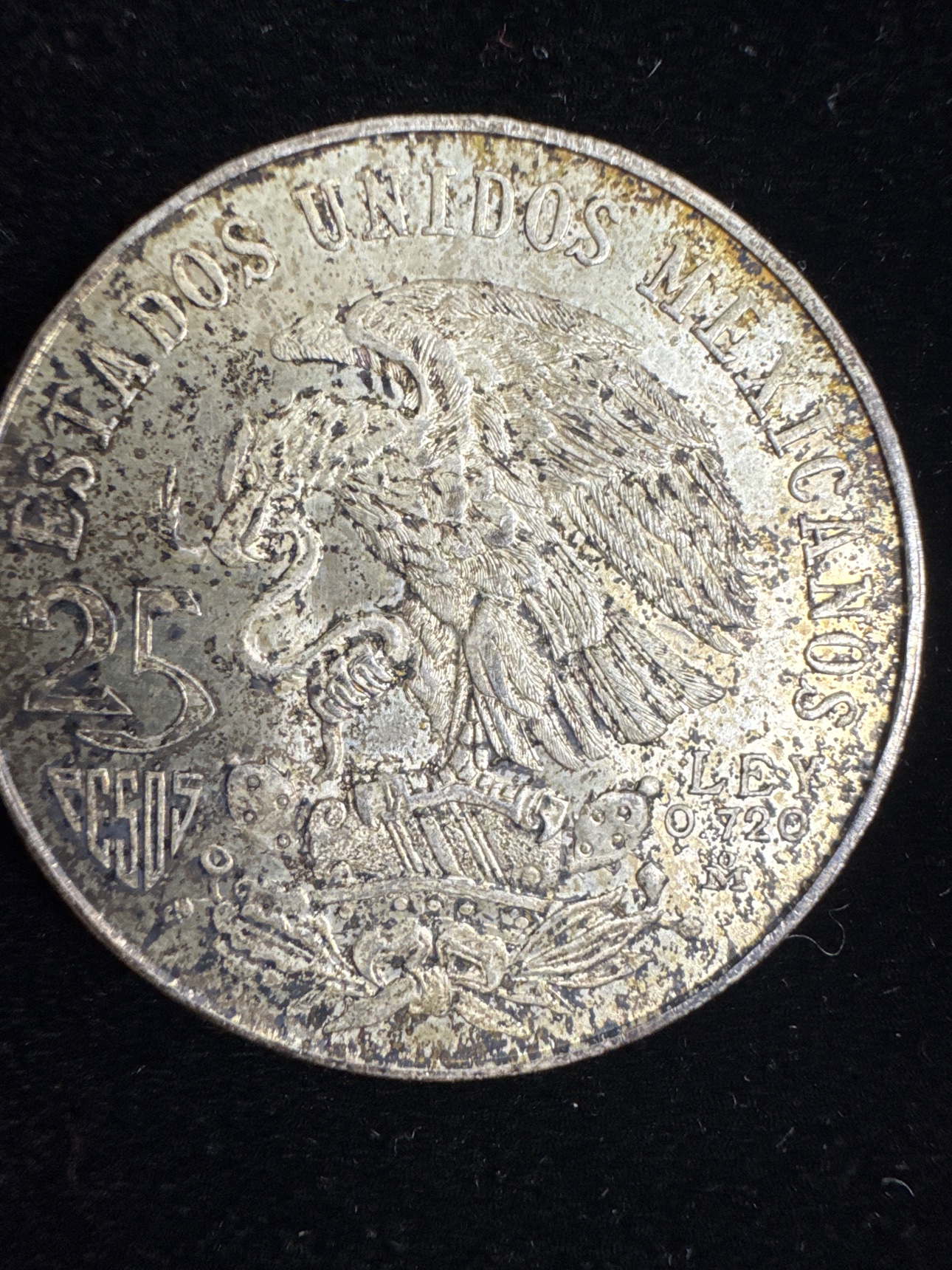 Eagle side of the 1968 Mexico 25 pesos coin showing 25 PESOS and LEY 0.720