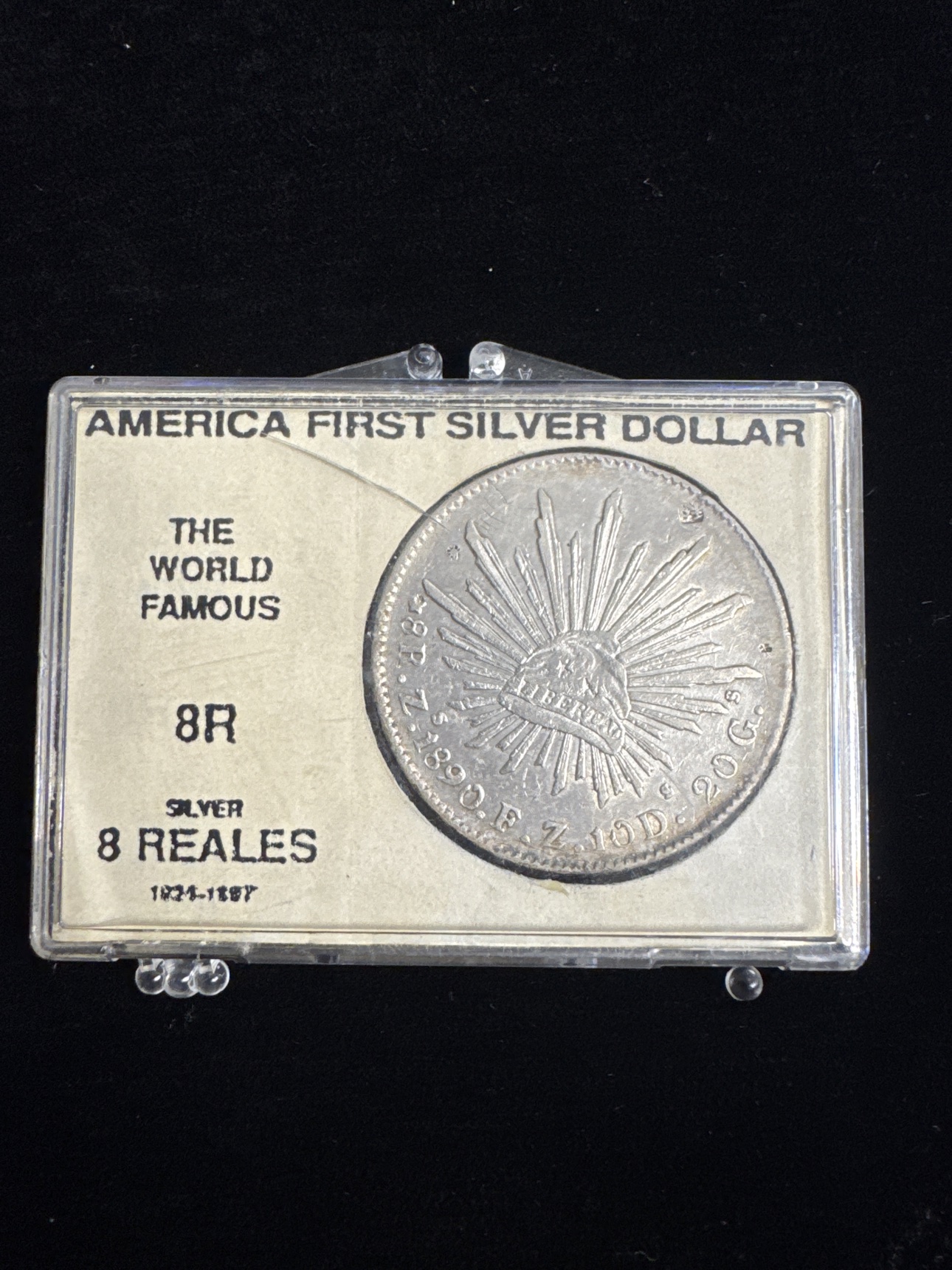 Cap-and-rays side of the circulated 1890 Mexico 8 reales silver coin in its display holder