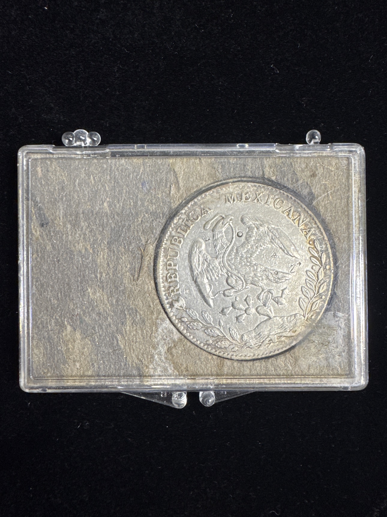 Eagle side of the circulated 1890 Mexico 8 reales silver coin in its display holder
