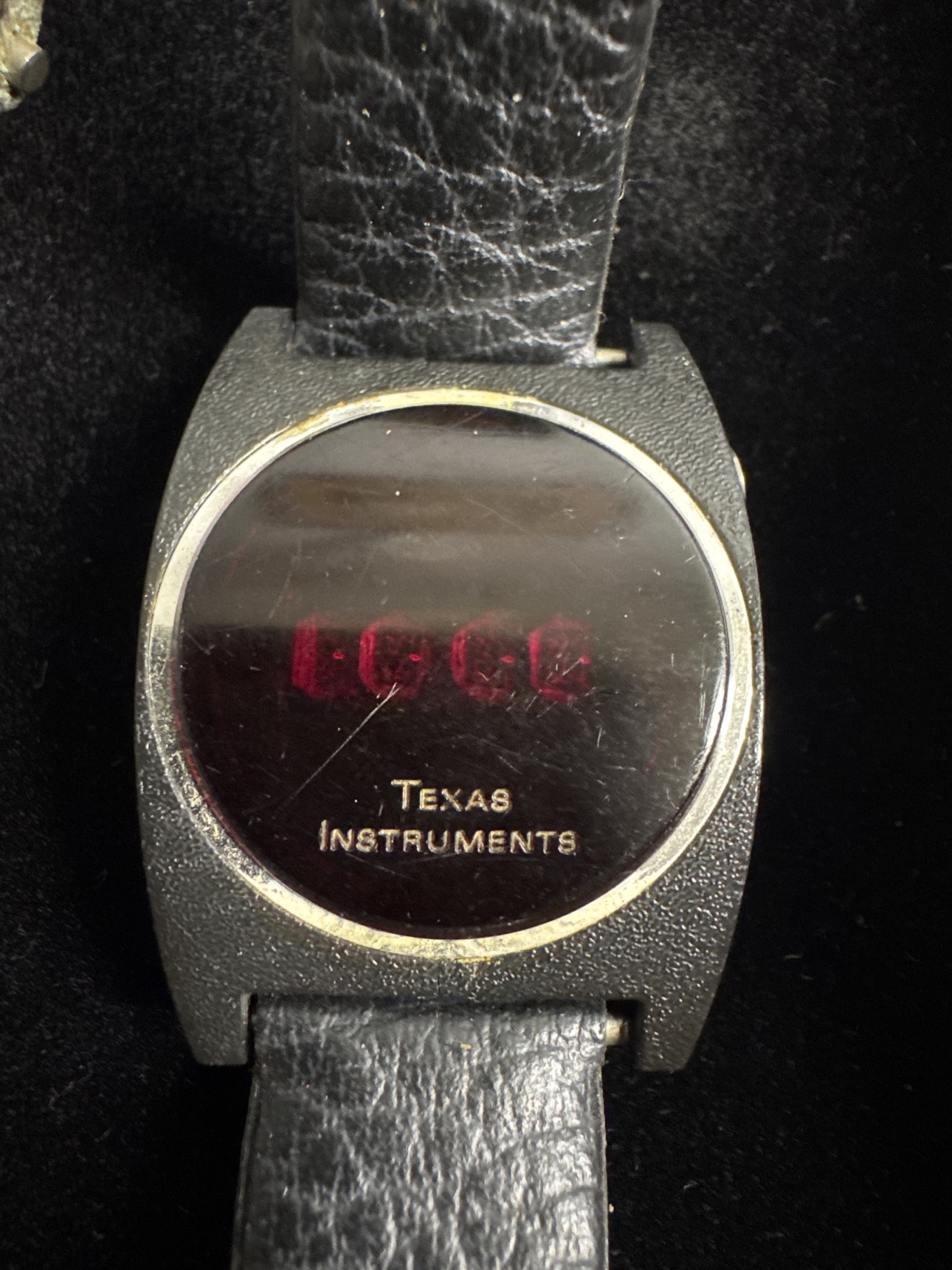 Close-up of the round-case Texas Instruments red LED digital watch